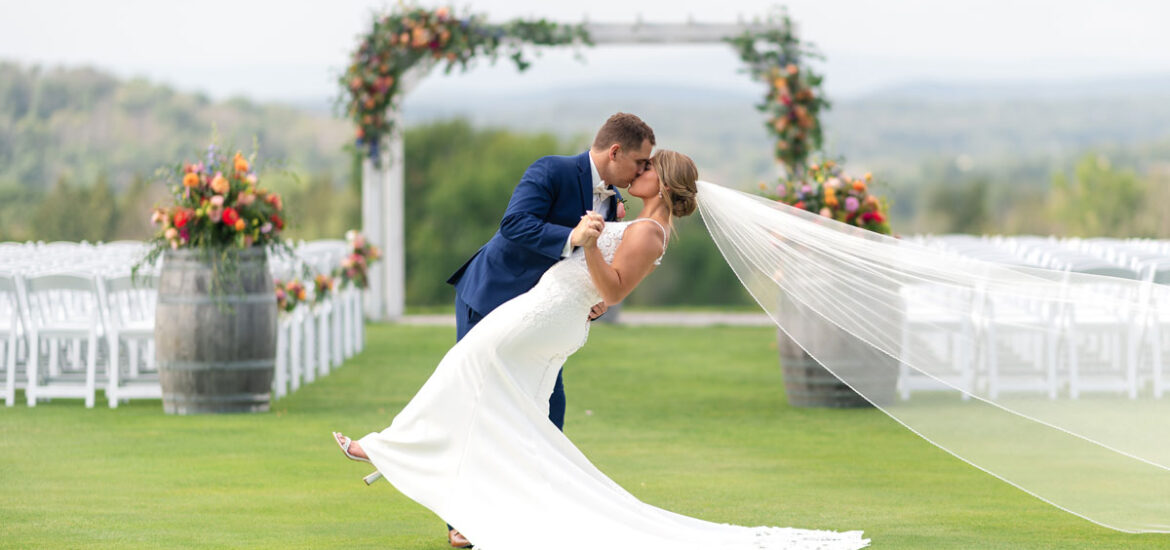 Wedding couple kissing at alter at SkyView golf course outside