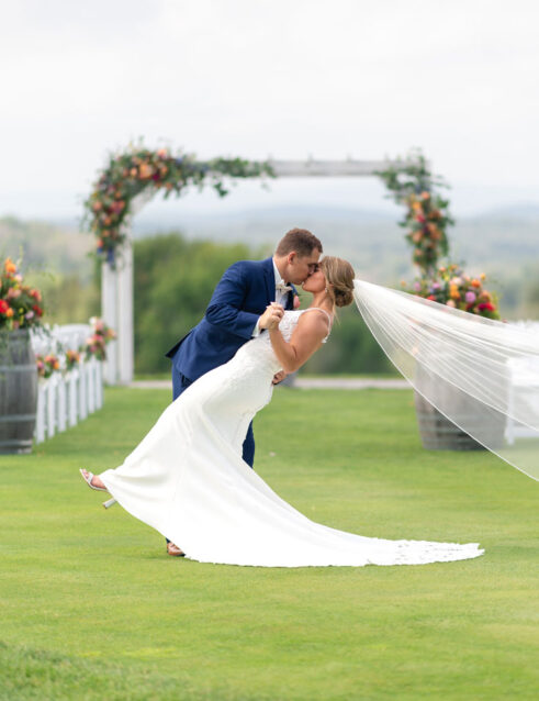 Wedding couple kissing at alter at SkyView golf course outside