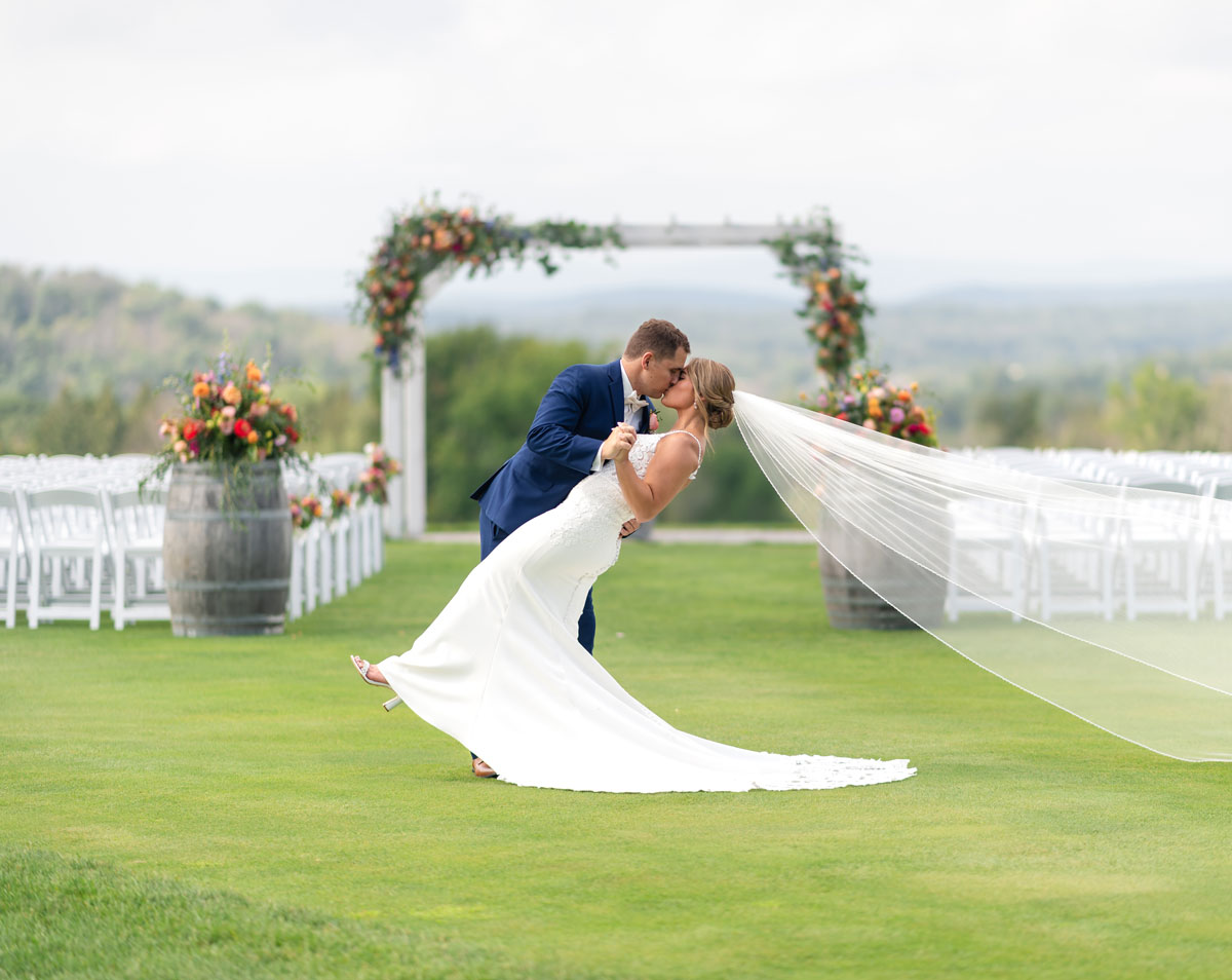 Wedding couple kissing at alter at SkyView golf course outside